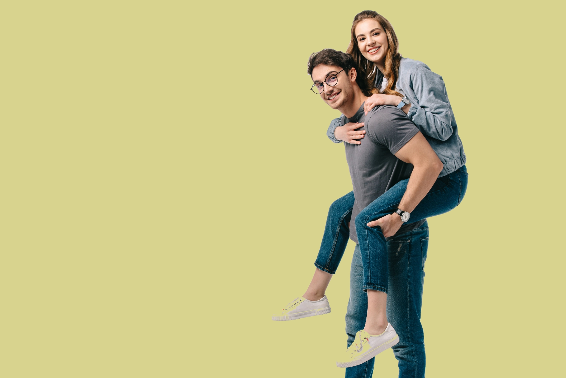 A man with glasses gives a woman a piggyback ride.